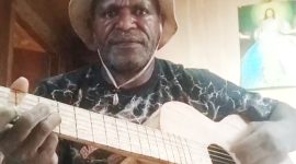 Marinus Edowai menunjukkan salah satu gitar kayu buatannya yang belum dicat.