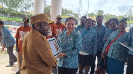 Ketua TP PKK Kabupaten Deiyai menyerahkan Piagam penghargaan atas peraihan juara umum, Juara 2 Pakaian adat, dan Talingkar Cinta di ajang Festival Tifa di Timika 2025.