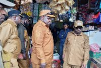Bupati Deiyai, Melkianus Mote, S.T., saat berdialog langsung dengan salah satu pedagang pasar Wagehete Deiyai 15/09/2025, dalam upaya menekan harga sembako agar kembali normal.