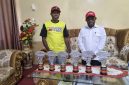 Pengurus IMI Deiyai, John Mote, menyerahkan trofi Juara Umum ke-2 Kejurnas Motoprix kepada Bupati Deiyai, Melkianus Mote.