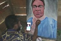 Derion Adii sedang Melukis Wajah Kepala Dinas Sosial Ibu Yulita Mote, S.Si