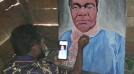 Derion Adii sedang Melukis Wajah Kepala Dinas Sosial Ibu Yulita Mote, S.Si