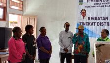 Asisten II Bidang Perekonomian dan Pembangunan, Mesak Pakage, S.Sos., menyerahkan bantuan Alat Peraga Edukatif (APE) kepada perwakilan PAUD pada Mini Lokakarya Tingkat Distrik DP3AKB di SMP Negeri Tigi Barat (21/11).