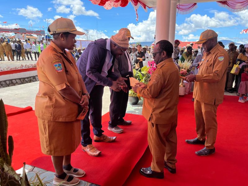 Bupati Deiyai, Melkianus Mote, ST, menyerahkan penghargaan kepada salah satu Perintis dalam rangkaian HUT ke-17 Kabupaten Deiyai, Rabu (26/11/2025).