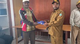 Kepala Dinas Pertanian Kabupaten Deiyai, Aleks Pigai, M.Pd. (kiri), saat menyerahkan secara simbolis pakaian Batik Korpri kepada salah satu tenaga kontrak di Kantor Dinas Pertanian Deiyai, Selasa (10/2/2025).