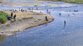 Masyarakat sedang mandi dan cuci baju di muara kali Oneibo di masa musim kemarau. 